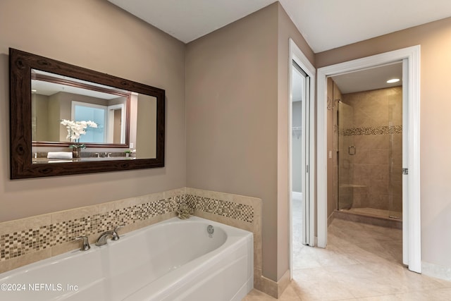 bathroom featuring independent shower and bath and tile patterned floors