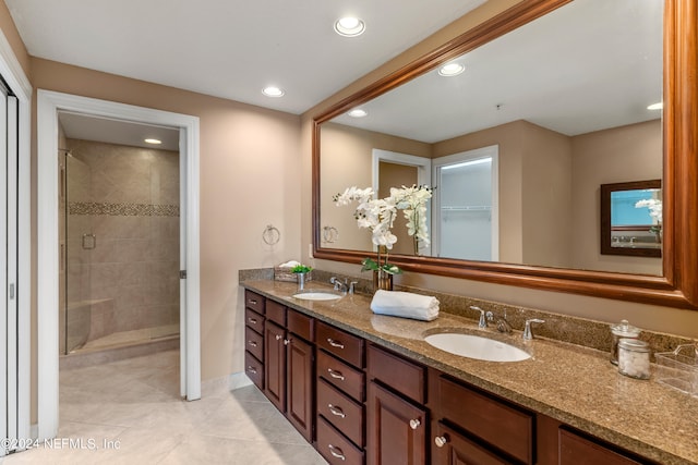 bathroom featuring vanity, a shower with shower door, and tile patterned floors