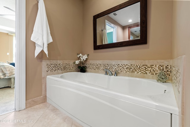 bathroom with tile patterned flooring and a bathing tub