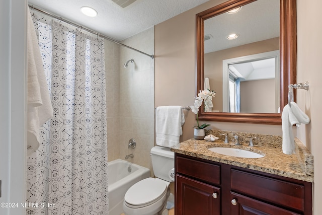 full bathroom featuring vanity, a textured ceiling, shower / tub combo with curtain, and toilet