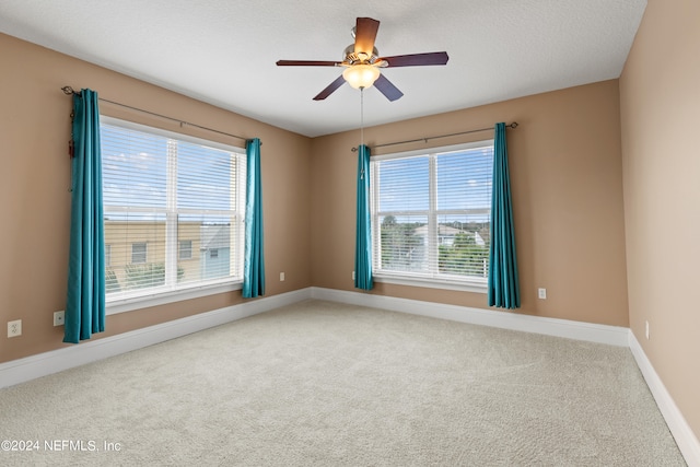 empty room with carpet, a textured ceiling, and ceiling fan