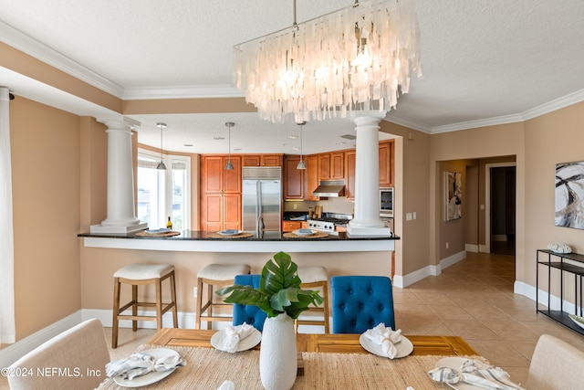 tiled dining space featuring an inviting chandelier, ornamental molding, and a textured ceiling