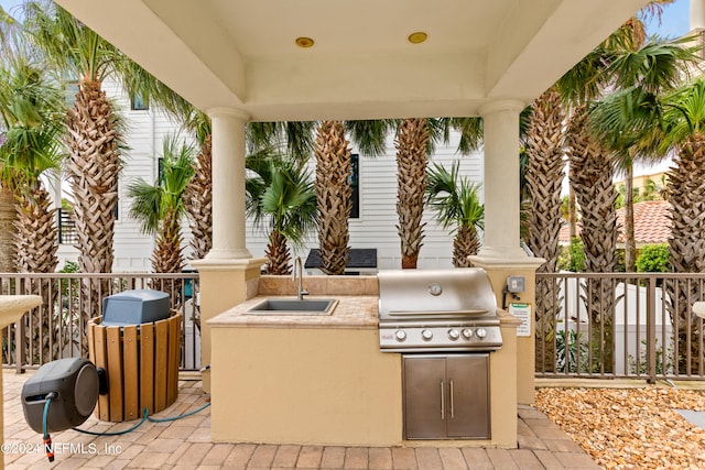 view of patio / terrace featuring area for grilling and sink