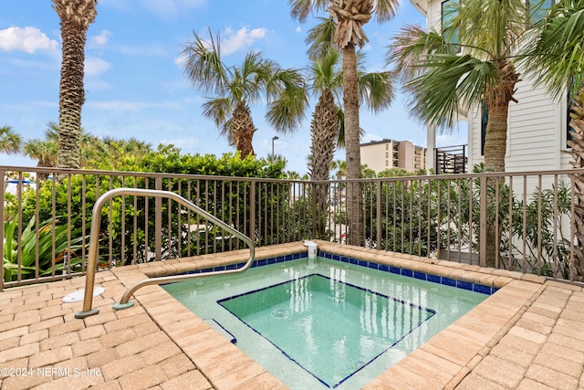 view of pool with an in ground hot tub