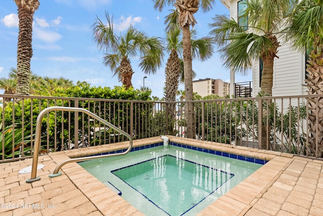 view of pool with an in ground hot tub