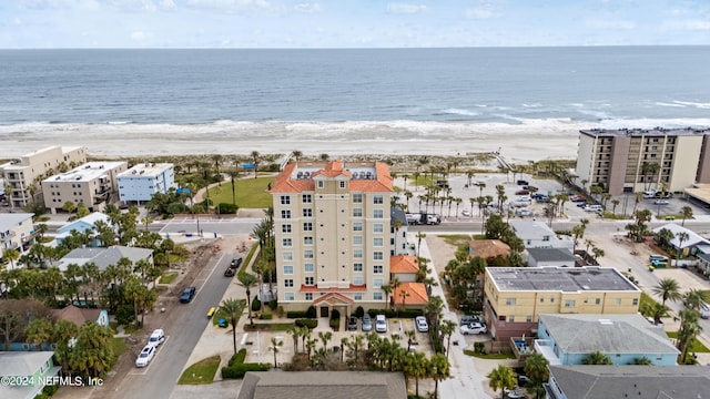 birds eye view of property with a view of the beach and a water view