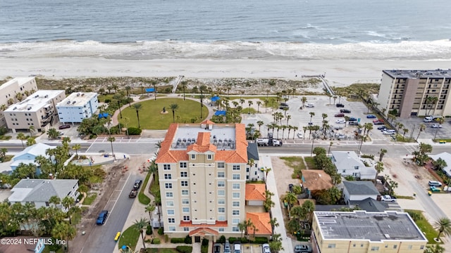 birds eye view of property featuring a water view and a view of the beach