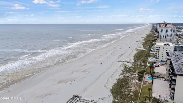 bird's eye view with a water view and a beach view