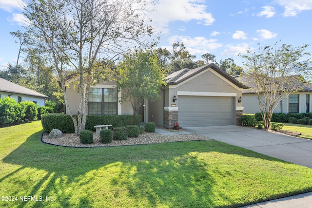 view of front of property featuring an attached garage, concrete driveway, stucco siding, and a front yard