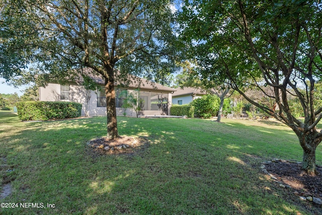 view of yard featuring a sunroom