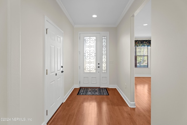 foyer featuring ornamental molding and hardwood / wood-style flooring