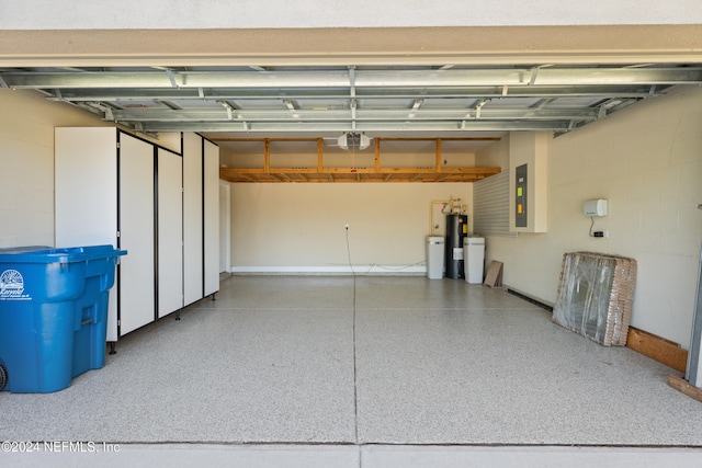 garage featuring a garage door opener, electric panel, and electric water heater