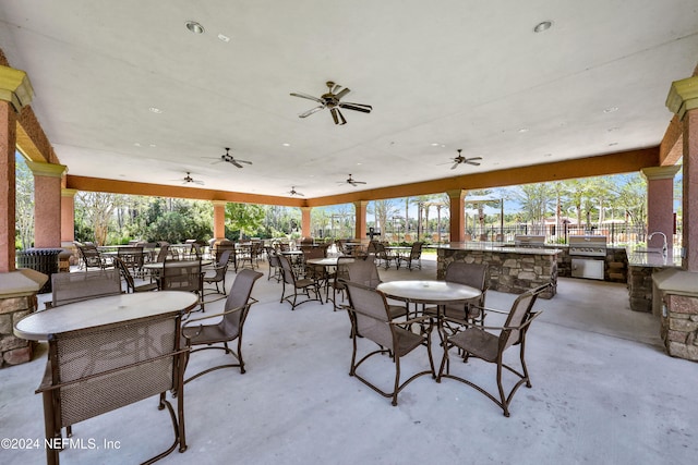 view of patio featuring ceiling fan and exterior kitchen