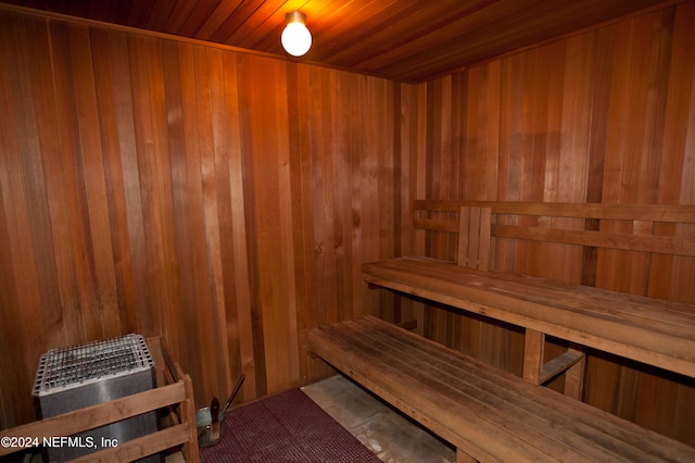 view of sauna with wood walls and wooden ceiling