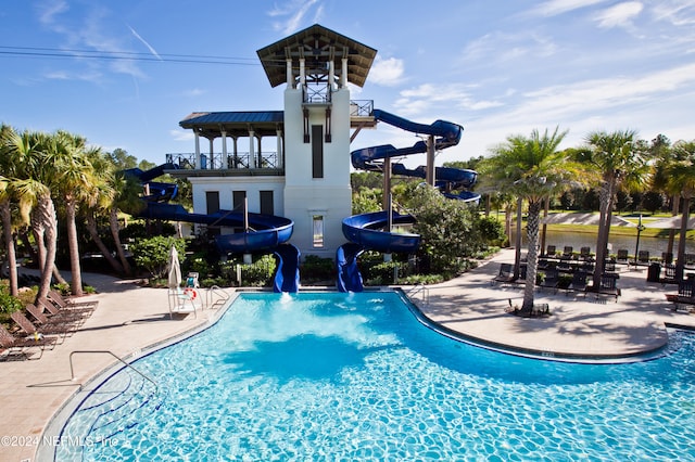 view of swimming pool featuring a patio and a water slide