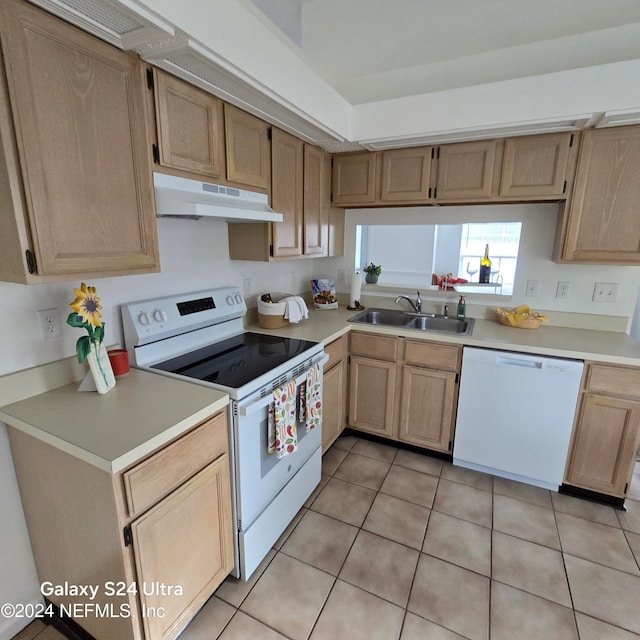 kitchen with light brown cabinets, sink, white appliances, and light tile patterned floors