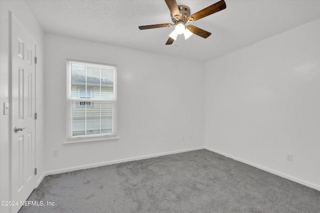 unfurnished room featuring ceiling fan, a textured ceiling, and carpet