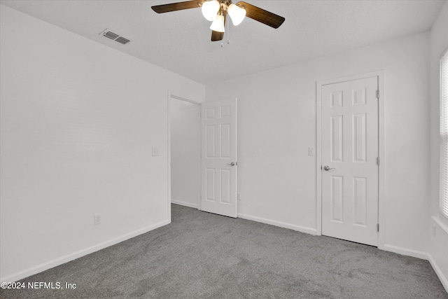 unfurnished bedroom with ceiling fan and light carpet