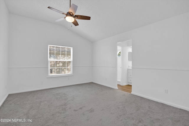 carpeted empty room with lofted ceiling and ceiling fan