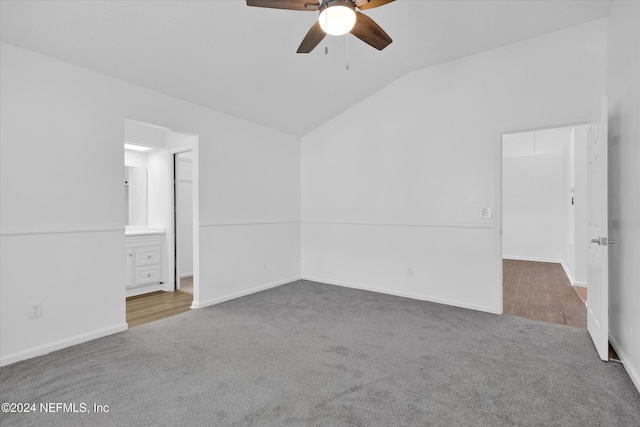 empty room with lofted ceiling, ceiling fan, and wood-type flooring