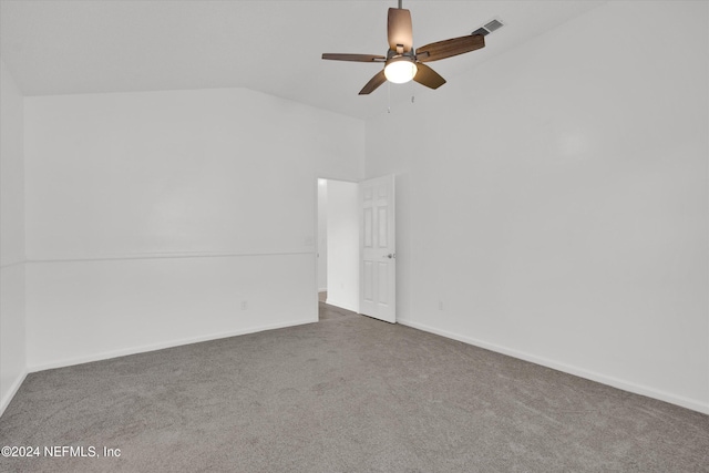 carpeted empty room featuring ceiling fan and vaulted ceiling