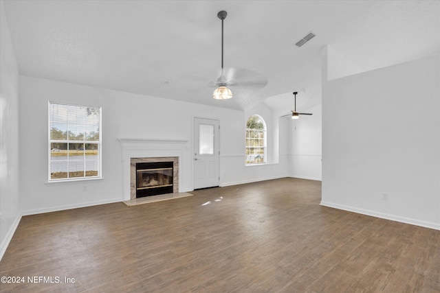 unfurnished living room featuring ceiling fan, dark hardwood / wood-style floors, and lofted ceiling