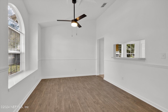 spare room featuring hardwood / wood-style floors, ceiling fan, plenty of natural light, and high vaulted ceiling