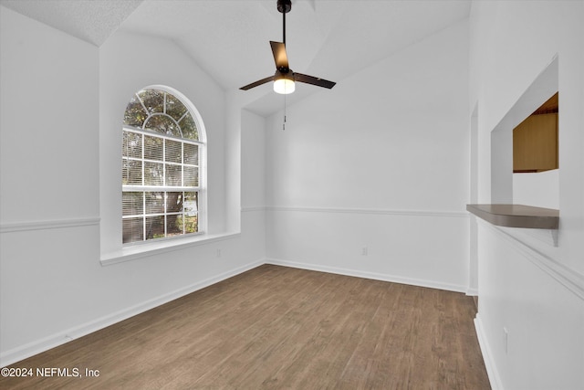 interior space with hardwood / wood-style floors, ceiling fan, a textured ceiling, and vaulted ceiling