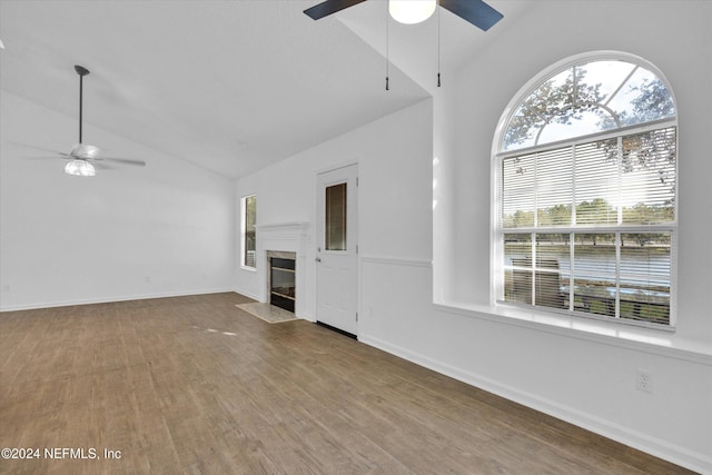 unfurnished living room featuring lofted ceiling, ceiling fan, and wood-type flooring