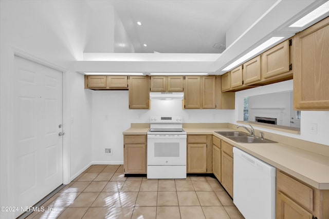 kitchen featuring light brown cabinetry, sink, white appliances, and light tile patterned floors