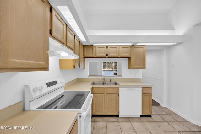 kitchen with light brown cabinetry, white appliances, sink, and light tile patterned floors