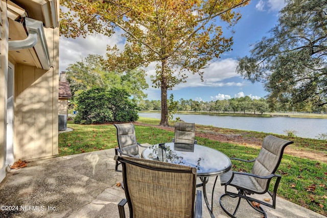 view of patio / terrace featuring central AC unit and a water view