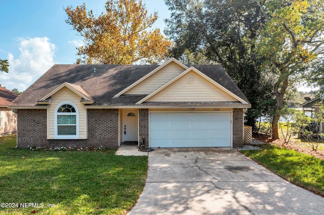 view of front of home with a front yard and a garage