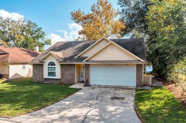 view of front of property with a garage and a front lawn