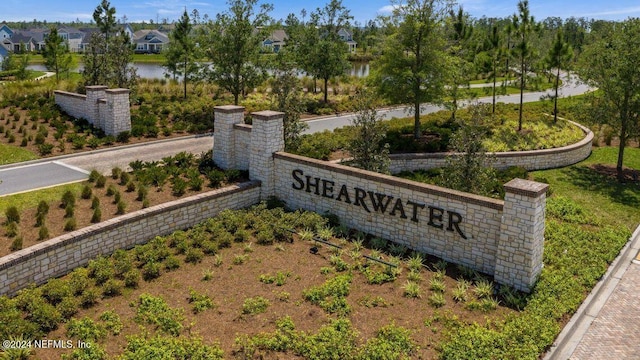 community sign with a water view