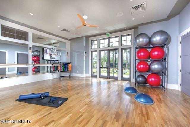 exercise area with hardwood / wood-style floors, french doors, and ceiling fan