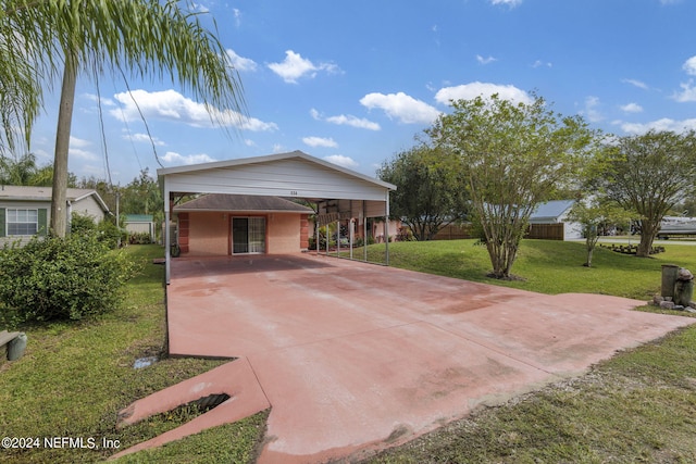 view of front facade with a front yard and a carport