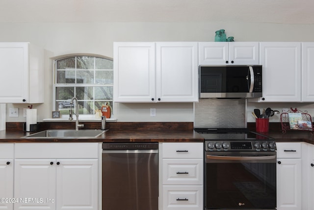 kitchen featuring stainless steel appliances and white cabinets