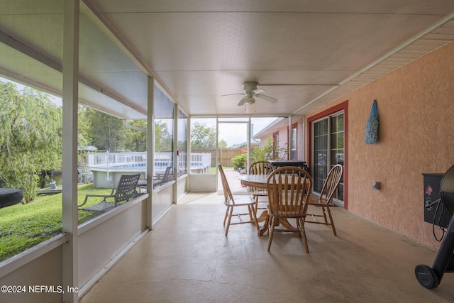 sunroom / solarium featuring ceiling fan