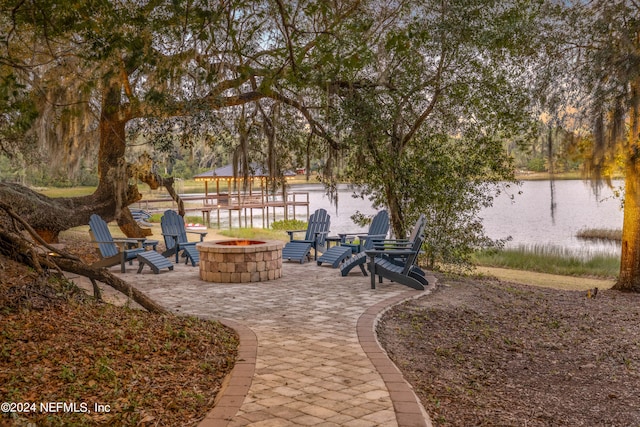 exterior space with a fire pit and a water view