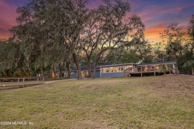 yard at dusk with a wooden deck