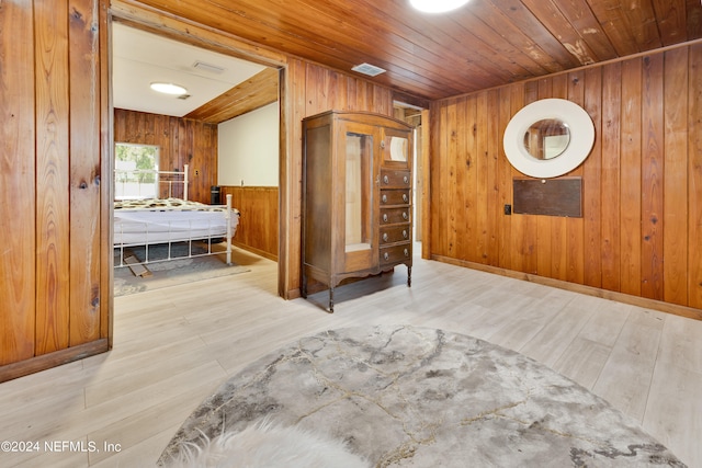 interior space with wood ceiling, hardwood / wood-style flooring, and wooden walls