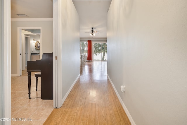 corridor featuring light hardwood / wood-style floors and ornamental molding