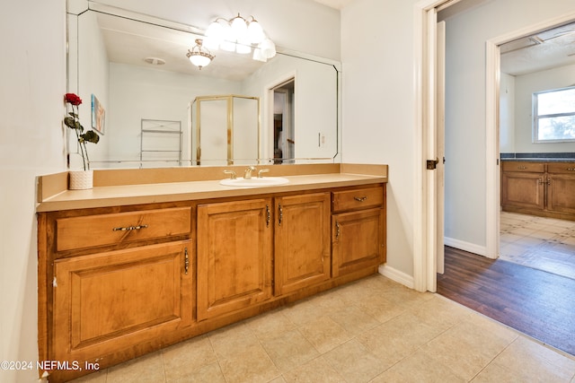 bathroom featuring vanity, hardwood / wood-style flooring, and an enclosed shower