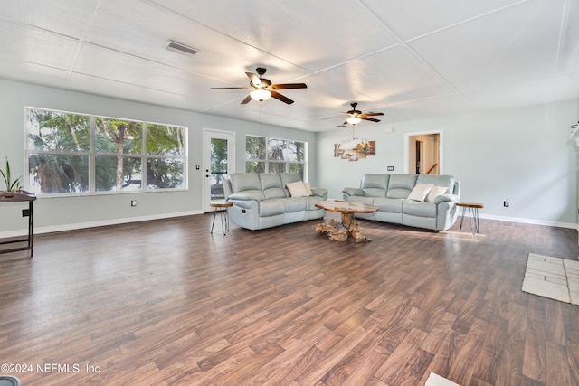 living room with dark wood-type flooring and ceiling fan