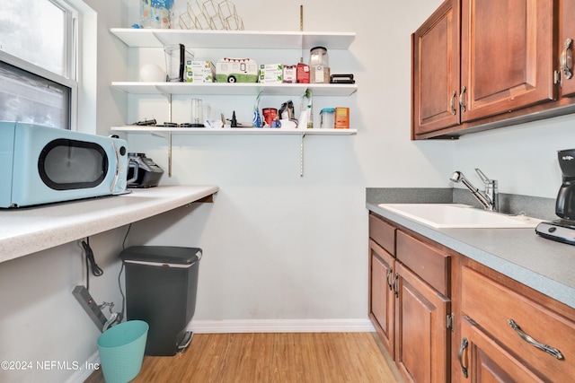 washroom with sink and light hardwood / wood-style floors