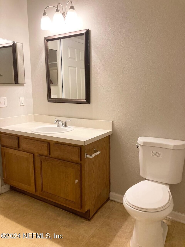 bathroom featuring vanity, toilet, and tile patterned floors