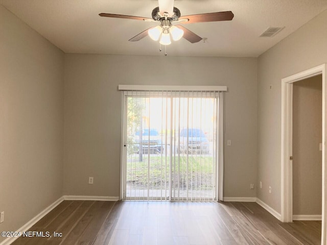 empty room featuring hardwood / wood-style floors and ceiling fan