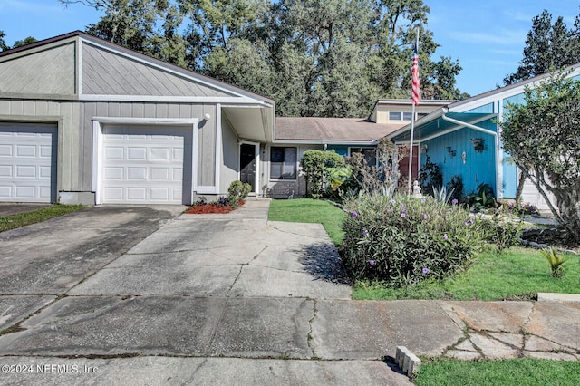 view of front facade with a front yard and a garage