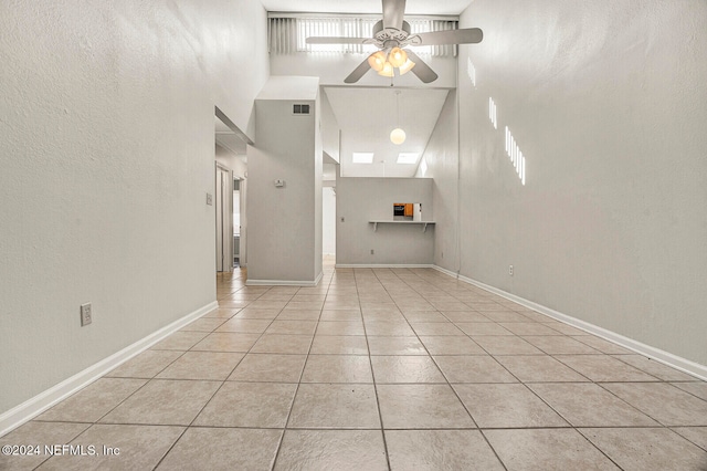 tiled foyer entrance featuring high vaulted ceiling and ceiling fan